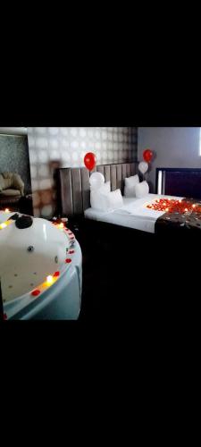 a bathroom with two beds and a bathtub in a room at Viagio hoteL in Yerevan