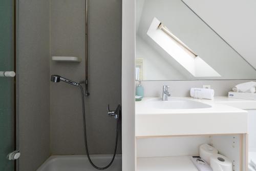 a bathroom with a shower and a sink at Hotel Ochsen in Uster