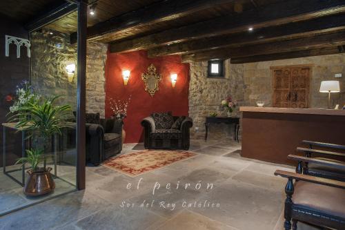 
a living room filled with furniture and a fire place at El Peiron in Sos del Rey Católico
