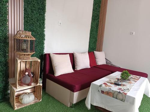 a living room with a couch and a bird cage at Нощувки "Феникс" in Devin