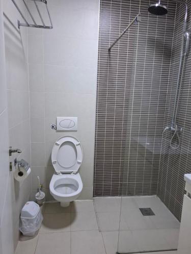 a bathroom with a shower and a toilet with a glass door at VilaMihaela in Skopje