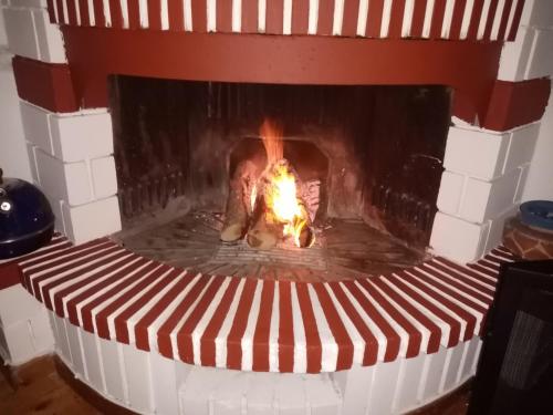 a brick fireplace with a fire in it at Olympos House in Litochoro