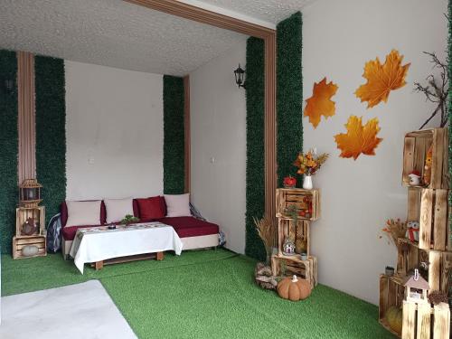 a living room with a couch and green carpet at Нощувки "Феникс" in Devin