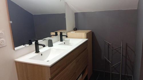 a bathroom with two sinks and a mirror at Chalet vue panoramique in Fillinges