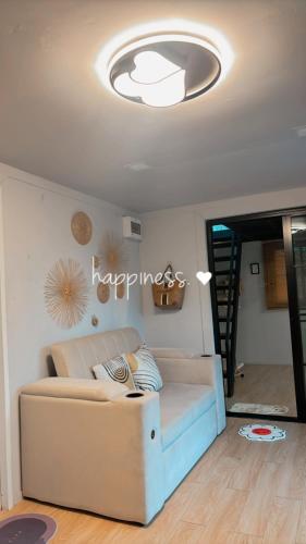 a living room with a couch and a ceiling at Cana Garden House 1 โฮมสเตย์ in Ban Khok