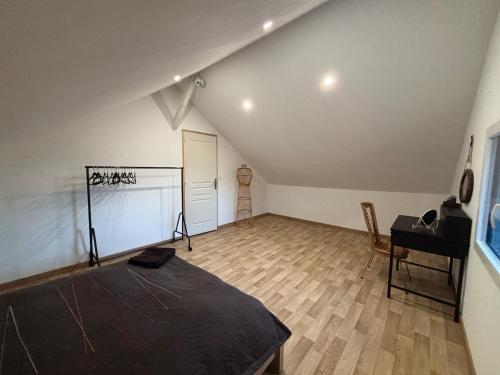 a attic room with a bed and a desk in it at 1930 house in La Marbellière, 2 bedrooms in Joue-les-Tours