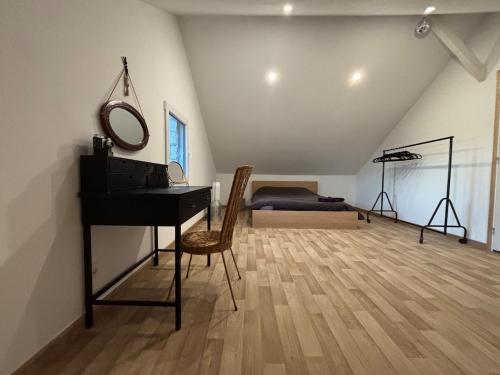a room with a piano and a bedroom with a bed at 1930 house in La Marbellière, 2 bedrooms in Joue-les-Tours