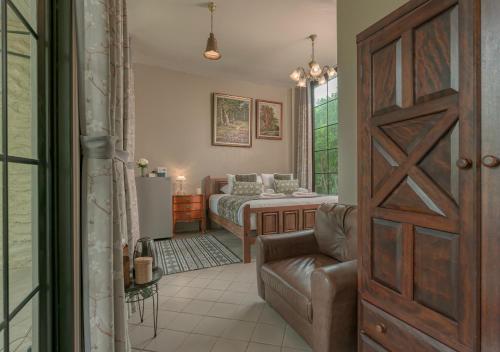 a bedroom with a bed and a couch and a door at VANA Homestay in Ban Tai
