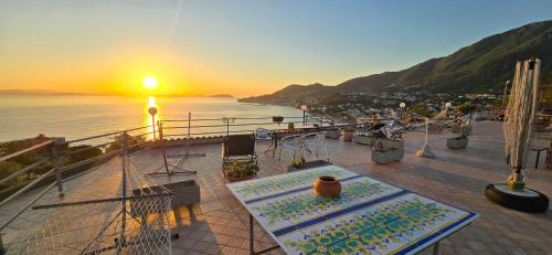 a deck of a boat with the sunset in the background at Appartamenti Miramare in Collina in Ischia