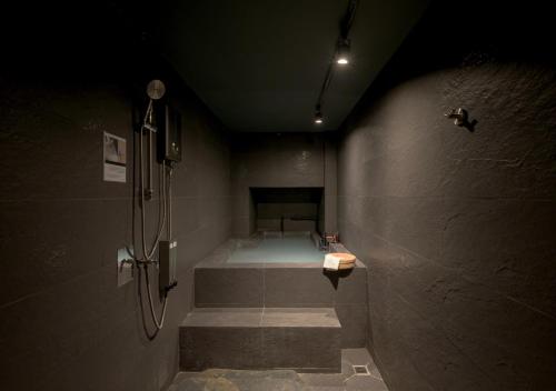 a bathroom with a shower and stairs in a room at VANA Homestay in Ban Tai
