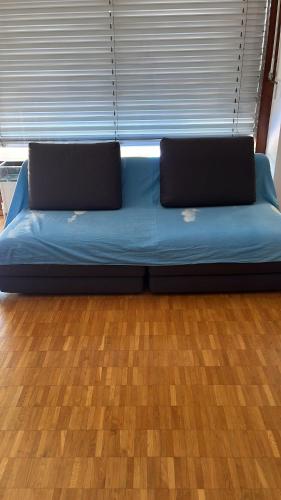 a blue bed with two laptops on top of it at Lugano Breve Soggiorno in Viganello