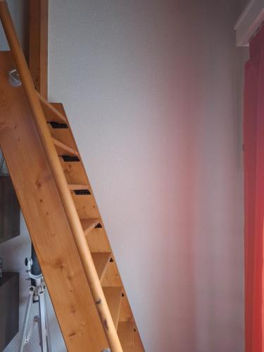 a wooden staircase in a room with a wall at Les balcons du Rhône in Daillon