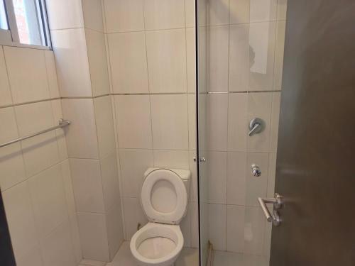 a bathroom with a toilet and a shower at Lyra in Cochabamba