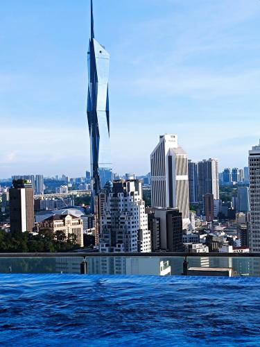 a view of a city skyline from the water at The Luxe & Colony Infinitum KLCC by CoupleStay in Kuala Lumpur