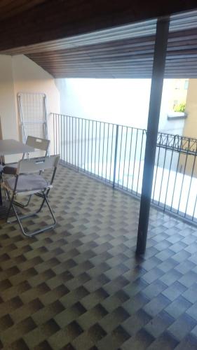 a room with two chairs and a table on a balcony at Fair Heaven - Modern Stay Near Metro Bisceglie and San Siro in Milan