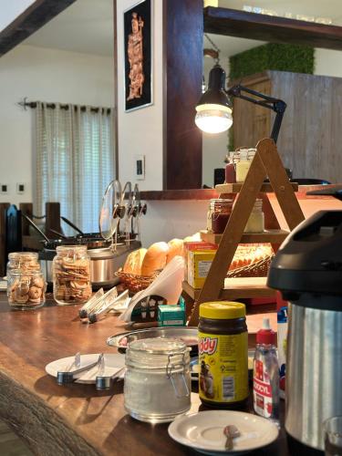 a kitchen counter top with food on it at Cocanha Beach Pousadas in Caraguatatuba