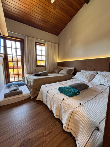 Postel nebo postele na pokoji v ubytování Casa Duplex Praia da Bacutia Enseada Azul