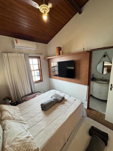 Giường trong phòng chung tại Casa Duplex Praia da Bacutia Enseada Azul