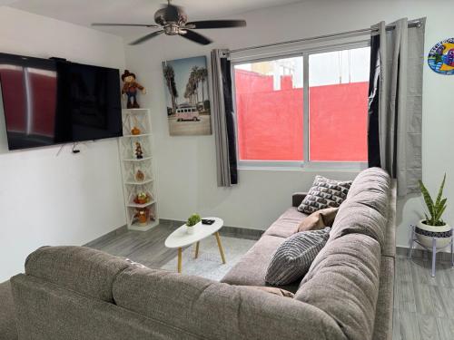a living room with a couch and a tv at Modern Cozy Retreat Ideal for Work, Relax & Enjoy in Xalapa