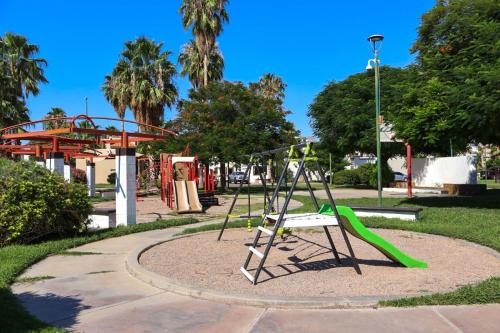 a playground with a slide in a park at Casa Serena in Hermosillo