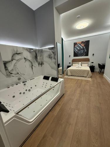 a bedroom with a large bed and a wall with a painting at Ventura Luxury in Alicante