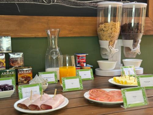 a wooden table topped with plates of food and drinks at Hotel Boutique Parque Brasil in Antofagasta