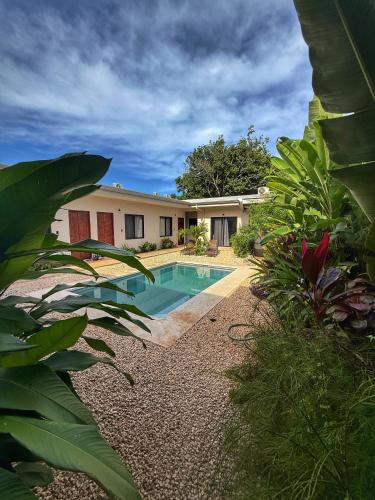 a house with a swimming pool in the yard at Hotel Huacas in Huacas