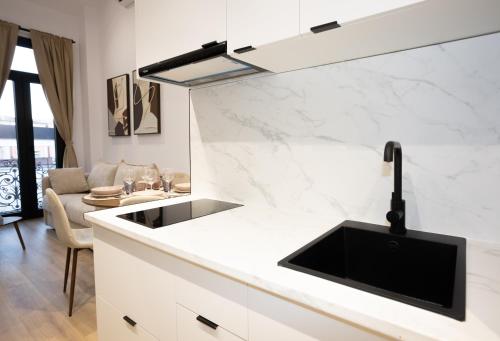 a kitchen with a sink and a counter top at Dorian Suites in Monforte de Lemos