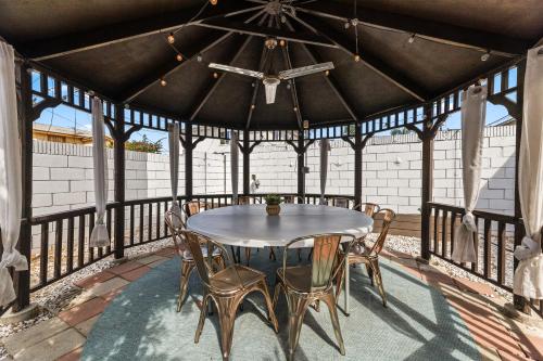 a wooden gazebo with a table and chairs on a patio at Los Angeles charming big house, king bed, parking, EV in Los Angeles