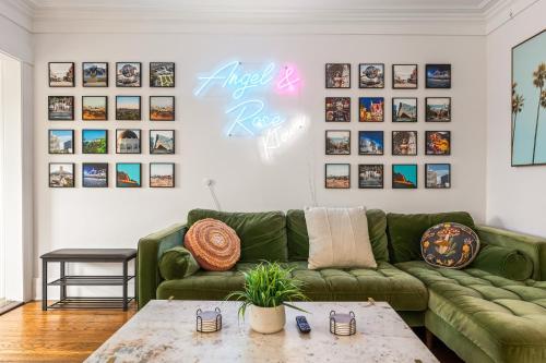 a living room with a green couch and a table at Los Angeles charming big house, king bed, parking, EV in Los Angeles
