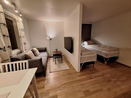 a small living room with a couch and a table at Central and comfortable apartment in Tromsø in Tromsø