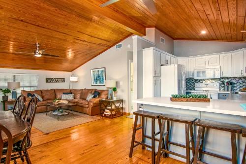 a kitchen and living room with wooden ceilings at Charming Green Riverfront Stay, New Braunfels in New Braunfels