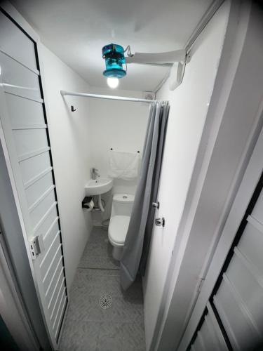 a small bathroom with a toilet and a blue light at La Casona Xalapa, céntrica y lugar muy tranquilo in Xalapa