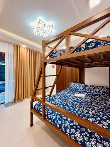 a bedroom with two bunk beds in a room at Casa DaLuz Hotspring Resort in Los Baños