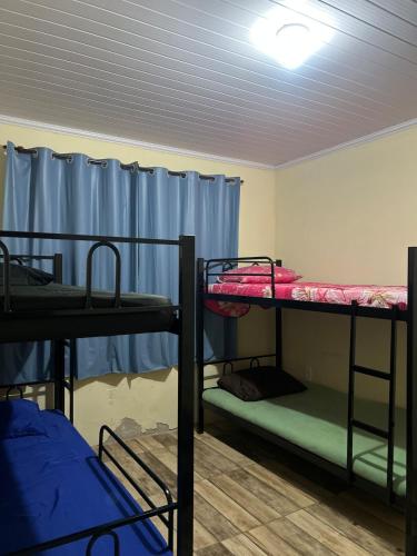 a room with three bunk beds in it at Chácara vó Zenilda in Itatiaia