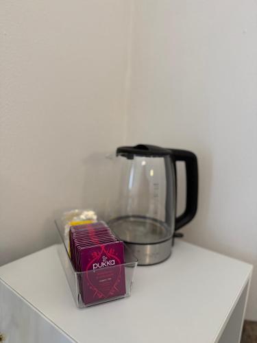 a coffee pot and a box of food on a counter at Casa Gien in Ferrara