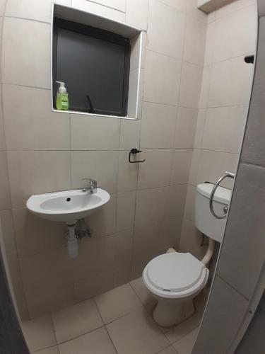 a bathroom with a toilet and a sink at Self-catering rooms Florida in Roodepoort