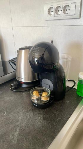a coffee maker sitting on a kitchen counter with eggs at Riverside Nis in Niš