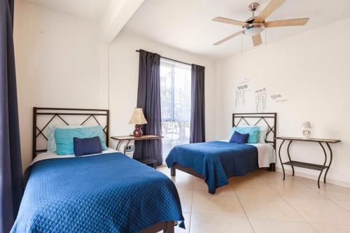 a bedroom with two beds and a ceiling fan at Casa GOGA in Oaxtepec