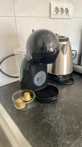 a coffee maker sitting on a counter next to a toaster at Riverside Nis in Niš