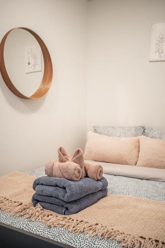 a pile of towels on a table with a mirror at Apartment in Downtown Toronto in Toronto