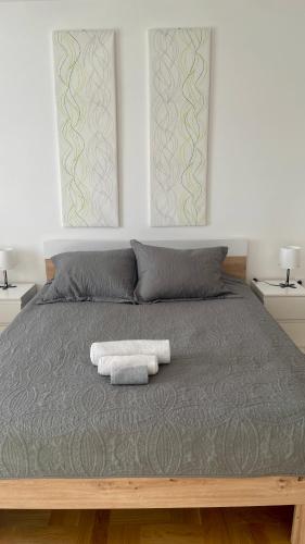 a bedroom with a bed with two towels on it at Riverside Nis in Niš
