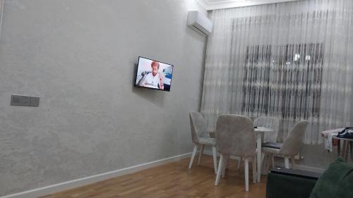 a living room with a tv on a wall at Banu House in Sumqayyt