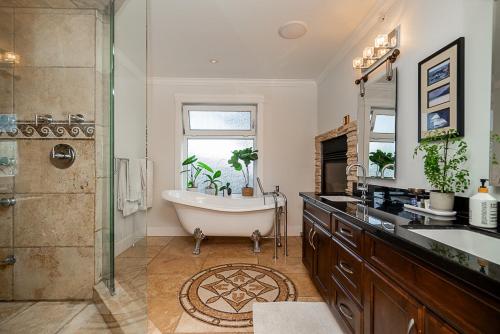 a bathroom with a tub and a sink and a shower at World Cup Coastal Getaway in White Rock