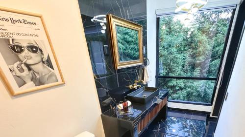 a bathroom with a sink and a window and a picture at Veta Corona in Tlalpujahua de Rayón