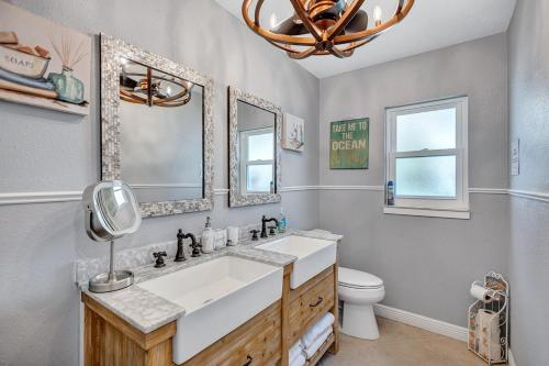 a bathroom with a sink and a toilet and a mirror at Hernando Beach Gulf Access, Dock & Heated Pool in Hernando Beach