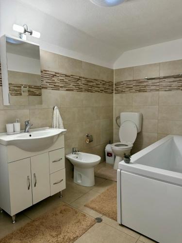 a bathroom with a sink and a tub and a toilet at Dream Crest in Bran