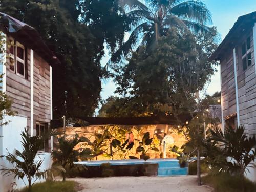 a building with a palm tree in the background at Cabana Bacalar in Bacalar