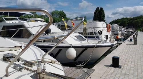 a group of boats are docked at a dock at Escale secrète Montargis Jacuzzi Terrasse Parking gratuit in Montargis