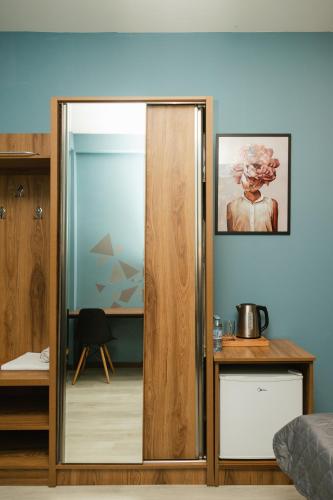 a sliding glass door in a room with a table at Hotel Graif Ti in Tbilisi City
